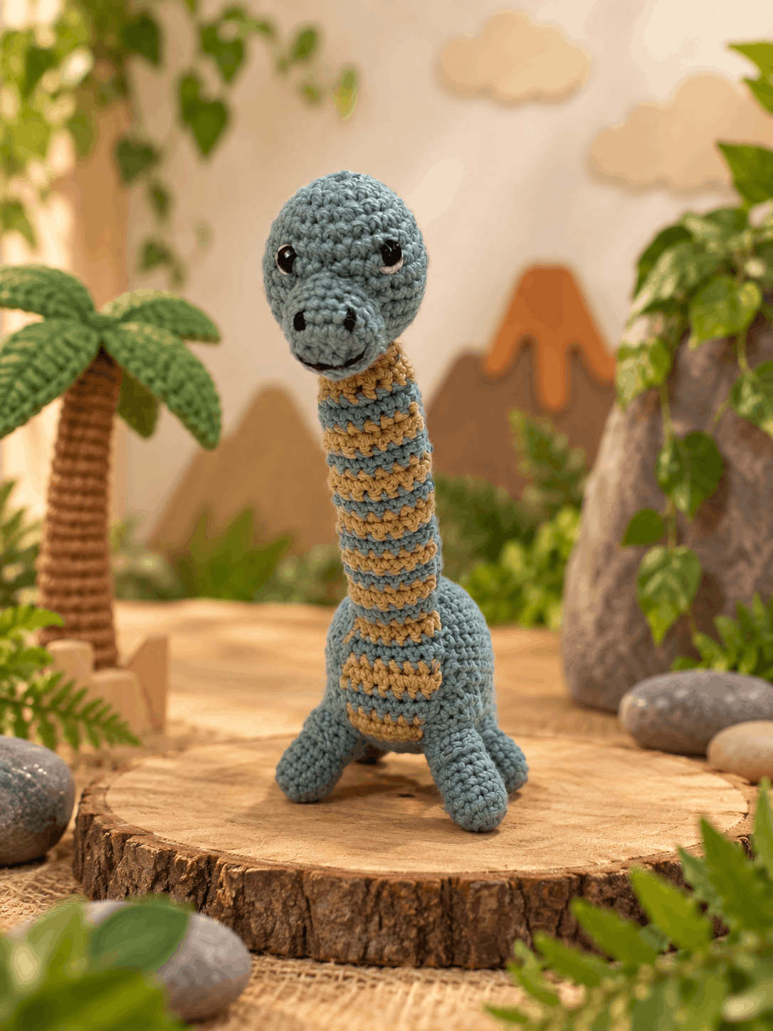 The finished blue and sand crochet brachiosaurus, seen from the front