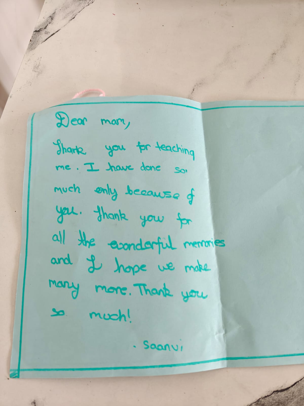 The inside of Saanvi's card, with a handwritten thank-you note in green marker